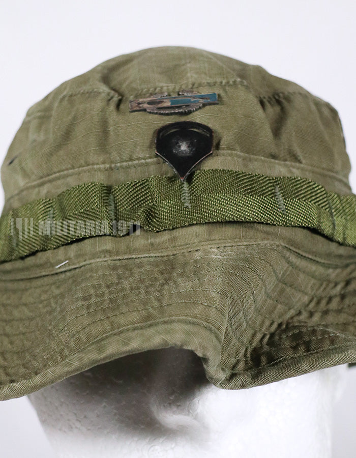 Real U.S. Army boonie hat with metal insignia, faded.