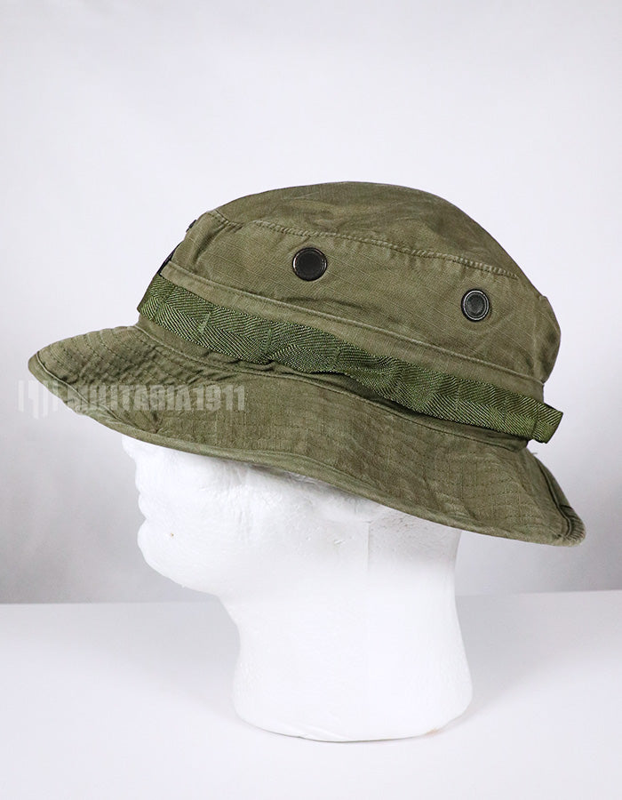 Real U.S. Army boonie hat with metal insignia, faded.