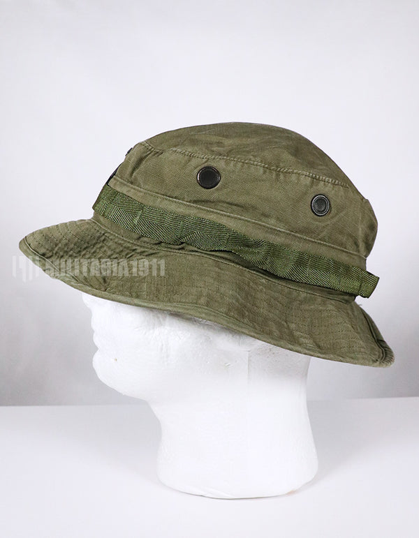 Real U.S. Army boonie hat with metal insignia, faded.