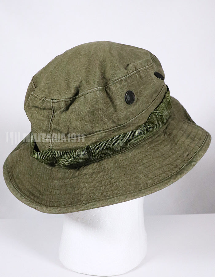 Real U.S. Army boonie hat with metal insignia, faded.