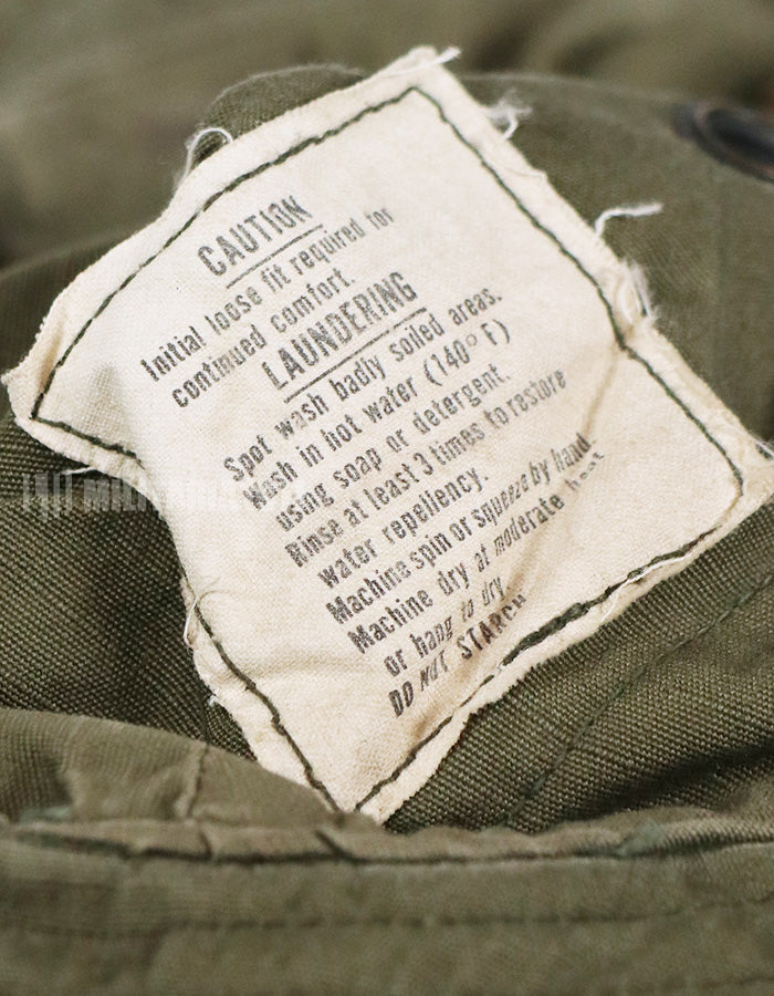 Real U.S. Army boonie hat with metal insignia, faded.